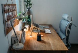 organised desk with laptop on a stand and an adjustable chair